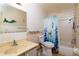 Bathroom featuring a sink, toilet, shower, and tub with a hummingbird shower curtain at 6025 Shore S Blvd # 410, Gulfport, FL 33707