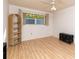 Bedroom featuring laminate flooring, ceiling fan, and natural light from the window at 6025 Shore S Blvd # 410, Gulfport, FL 33707