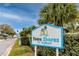 Welcoming sign for Town Shores of Gulfport community featuring lush landscaping and a tropical vibe at 6025 Shore S Blvd # 410, Gulfport, FL 33707