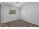 Bedroom with neutral carpet, a window offering natural light and a ceiling fan at 6337 S Lansdale Cir, Tampa, FL 33616