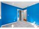 Bedroom with blue walls, tile flooring, and a mirrored closet offering ample storage at 6337 S Lansdale Cir, Tampa, FL 33616