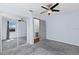 Carpeted bedroom with mirrored closet doors and a large window offering natural light at 6337 S Lansdale Cir, Tampa, FL 33616