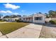 Street view of a one-story home with a driveway and bright exterior paint at 6337 S Lansdale Cir, Tampa, FL 33616