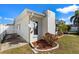Side view of the home featuring a Direct TV dish, garden beds, and partial fence at 6337 S Lansdale Cir, Tampa, FL 33616