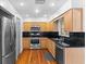 Well-equipped kitchen featuring stainless steel appliances, dark countertops, and classic wood cabinetry at 6337 S Lansdale Cir, Tampa, FL 33616