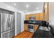Kitchen with stainless steel appliances and black granite countertops, providing modern functionality at 6337 S Lansdale Cir, Tampa, FL 33616