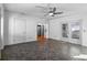 Bright living room featuring modern ceiling fan, fresh paint, and durable tile flooring at 6337 S Lansdale Cir, Tampa, FL 33616