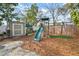 Backyard featuring a playset, shed, and ample space for outdoor activities at 6835 S Shamrock St, Tampa, FL 33616