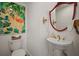 Elegant powder room with pedestal sink, flamingo artwork, and unique red mirror at 6835 S Shamrock St, Tampa, FL 33616