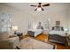 Inviting bedroom with two twin beds, a patterned rug, and shuttered windows, offering a comfortable and stylish space at 6835 S Shamrock St, Tampa, FL 33616