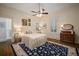 Serene bedroom with neutral decor, ceiling fan, and a stylish blue floral rug at 6835 S Shamrock St, Tampa, FL 33616