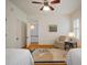 Bedroom with two twin beds, a patterned rug, and shuttered windows, offering a comfortable and stylish retreat at 6835 S Shamrock St, Tampa, FL 33616