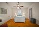Cozy bedroom with hardwood floors, ceiling fan, and natural light at 6835 S Shamrock St, Tampa, FL 33616