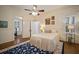 Bright bedroom with wooden floors, ceiling fan, and white trim, creating a cozy and inviting atmosphere at 6835 S Shamrock St, Tampa, FL 33616