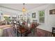 Charming dining room featuring a hardwood table with seating for six, plus backyard views at 6835 S Shamrock St, Tampa, FL 33616