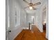 Hallway with hardwood floors, beadboard paneling, and natural light, creating a warm and inviting path at 6835 S Shamrock St, Tampa, FL 33616