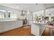 Bright and modern kitchen featuring white cabinets, stainless steel appliances, and hardwood floors at 6835 S Shamrock St, Tampa, FL 33616