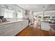 Stylish kitchen boasts white cabinets, stainless appliances, and backyard views at 6835 S Shamrock St, Tampa, FL 33616