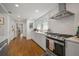 Bright kitchen featuring white cabinets, subway tile backsplash, and stainless steel appliances at 6835 S Shamrock St, Tampa, FL 33616