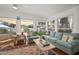 Sunny living room features a comfortable sofa, neutral color palette, and scenic backyard views at 6835 S Shamrock St, Tampa, FL 33616