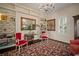 Bright living room showcasing large windows, built-in bookshelves, and vintage furniture at 6835 S Shamrock St, Tampa, FL 33616