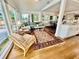 Bright living room with hardwood floors and big windows, with easy access to kitchen and dining at 6835 S Shamrock St, Tampa, FL 33616