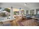 Relaxing living room featuring cozy seating, beautiful backyard view, and hardwood floors at 6835 S Shamrock St, Tampa, FL 33616