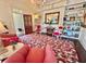 Cozy living room featuring bookshelves, a chandelier, and vibrant floral carpet at 6835 S Shamrock St, Tampa, FL 33616