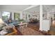 Open living room featuring hardwood floors, a comfortable couch, and easy access to dining at 6835 S Shamrock St, Tampa, FL 33616