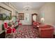 Bright living room showcasing large windows, built-in bookshelves, and vintage furniture at 6835 S Shamrock St, Tampa, FL 33616