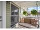 Cozy side porch with swing seat and decorative pillows and plants at 6835 S Shamrock St, Tampa, FL 33616