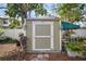 Exterior view of the shed with green paint and a white door frame at 6835 S Shamrock St, Tampa, FL 33616