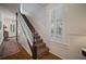 Staircase with hardwood floors, white wainscoting, and eye catching leopard print carpet at 6835 S Shamrock St, Tampa, FL 33616