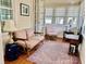 Bright sunroom featuring vintage furniture, natural light, and an elegant rug, creating a serene and stylish space at 6835 S Shamrock St, Tampa, FL 33616