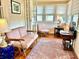 Cozy sunroom featuring vintage furniture, natural light, and an elegant rug, providing a relaxing and stylish space at 6835 S Shamrock St, Tampa, FL 33616