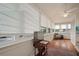 Bright sunroom with many windows, hardwood floors, and a ceiling fan for year-round comfort at 6835 S Shamrock St, Tampa, FL 33616