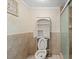 Small bathroom shows toilet, a shower, and shelving at 8343 Galewood Cir, Tampa, FL 33615