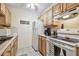 Efficient kitchen featuring bright cabinetry, white appliances, and tile flooring at 8425 112Th St # 104, Seminole, FL 33772