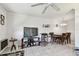 Open concept living room with dining area featuring tile floors and modern lighting at 8425 112Th St # 104, Seminole, FL 33772