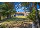 Fenced backyard featuring lush greenery, a patio, and mature trees at 913 Burlwood St, Brandon, FL 33511