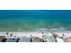 Breathtaking aerial shot of clear turquoise ocean waters meet pristine white sands alongside beachfront homes at 920 Spruce Dr, Belleair Beach, FL 33786