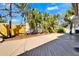 Open-air, bright wooden back deck with wooden fence and lush landscaping at 920 Spruce Dr, Belleair Beach, FL 33786