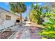 View of the backyard with a stone walkway leading to the back shed at 920 Spruce Dr, Belleair Beach, FL 33786