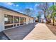 Wide wooden deck and sliding glass doors leading to the home's interior at 920 Spruce Dr, Belleair Beach, FL 33786
