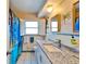 Updated bathroom with granite vanity, decorative mirrors and new flooring at 920 Spruce Dr, Belleair Beach, FL 33786