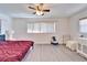 Bright bedroom with large windows, new floors, and a ceiling fan at 920 Spruce Dr, Belleair Beach, FL 33786