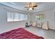 Bedroom features a large window, hardwood floors, side chairs, and a comfortable bed at 920 Spruce Dr, Belleair Beach, FL 33786