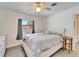 Bright bedroom with large windows, new floors, and a ceiling fan at 920 Spruce Dr, Belleair Beach, FL 33786