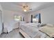 Bright bedroom with large windows, new floors, and a ceiling fan at 920 Spruce Dr, Belleair Beach, FL 33786