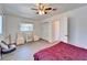 Bright bedroom featuring a ceiling fan, two side chairs, a closet, and wood-look flooring at 920 Spruce Dr, Belleair Beach, FL 33786